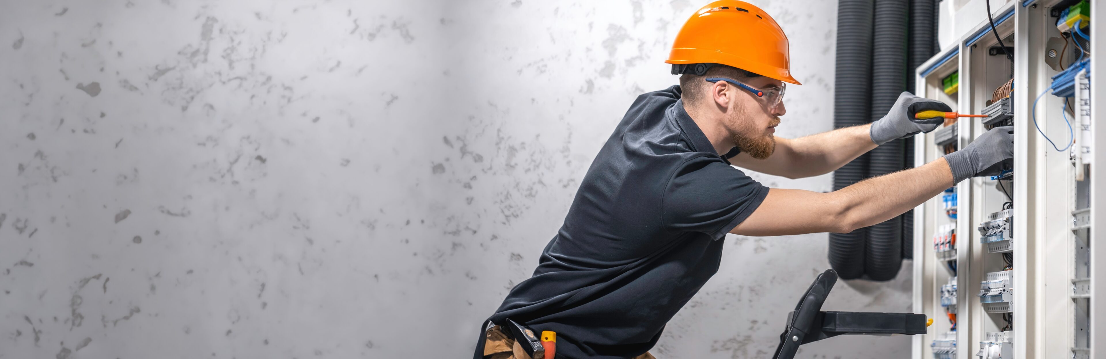 Electrician,Working,In,Switchboard,With,Electrical,Connection,Cable,,Copy,Space. Electrician,Working,In,Switchboard,With,Electrical,Connection,Cable,,Copy,Space.